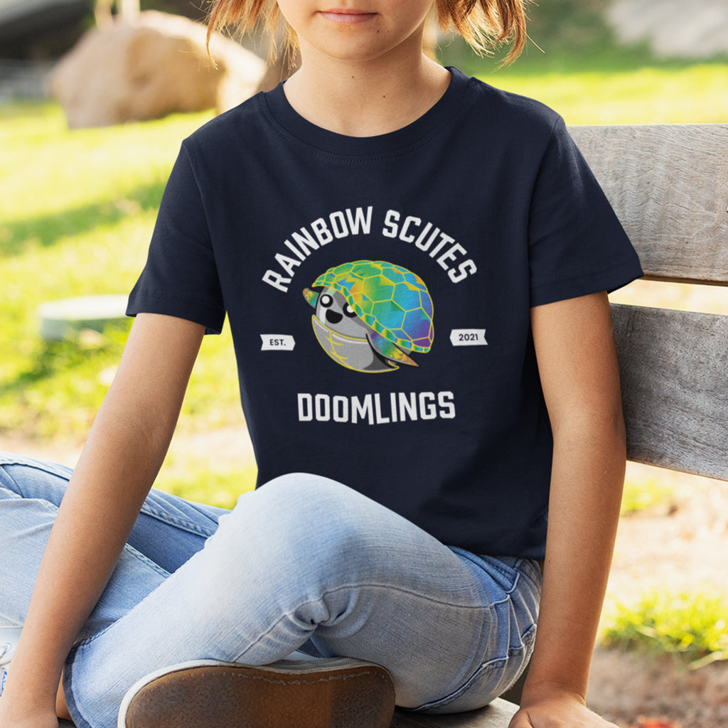 girl wearing rainbow scutes college tee kids - says rainbow scutes est. 2021 doomlings with picture of turtle