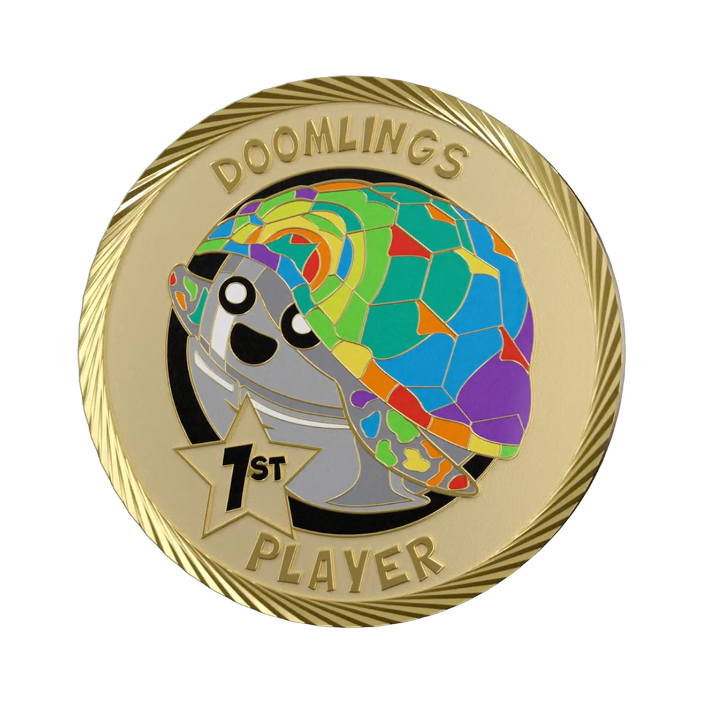 rainbow scutes doomlings first player medallion coin, gold coin that says doomlings 1st player with cute art of a rainbow turtle on it.